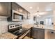 Updated kitchen with stainless steel appliances and granite countertops at 1475 S Quebec Way # H38, Denver, CO 80231