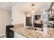 Kitchen features granite countertops, dark cabinets, and a double sink at 1475 S Quebec Way # H38, Denver, CO 80231