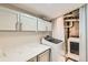 Bright laundry room with upper cabinets and modern appliances at 1475 S Quebec Way # H38, Denver, CO 80231