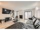 Living room features L-shaped sectional sofa, stone fireplace, and a large TV at 1475 S Quebec Way # H38, Denver, CO 80231