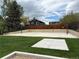 View of a community basketball court surrounded by landscaping and fencing on a bright, partly cloudy day at 9483 W 89Th Cir, Broomfield, CO 80021
