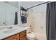 Bathroom featuring a classic vanity, toilet, tub, shower with curtain, and updated towel rack with towels at 9483 W 89Th Cir, Broomfield, CO 80021