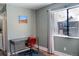 Bedroom with hardwood floors, a desk, a large window, and views of the building exterior at 9483 W 89Th Cir, Broomfield, CO 80021