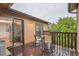 Exterior view of a wooden deck with seating and sliding glass doors, offering a cozy outdoor space at 9483 W 89Th Cir, Broomfield, CO 80021