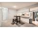 Bright dining area featuring bar seating, stainless steel appliances, and a view of an open floorplan at 9483 W 89Th Cir, Broomfield, CO 80021