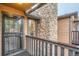 Cozy entryway shows a door with a security screen and a decorative stone chimney at 9483 W 89Th Cir, Broomfield, CO 80021
