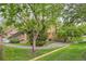 Inviting exterior with beautiful landscaping, a stone chimney, wood siding, and a charming walkway to the home's entrance at 9483 W 89Th Cir, Broomfield, CO 80021