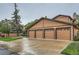 Spacious garages with elegant doors, complemented by lush landscaping and a well-maintained driveway at 9483 W 89Th Cir, Broomfield, CO 80021