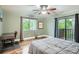 Comfortable main bedroom with hardwood floors, a ceiling fan, a desk, and a view onto the balcony at 9483 W 89Th Cir, Broomfield, CO 80021