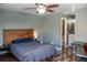 Spacious main bedroom with hardwood floors, ceiling fan, and a view into the ensuite bathroom at 9483 W 89Th Cir, Broomfield, CO 80021