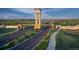 Impressive community entrance featuring a clock tower, signage, and beautifully landscaped roadways at 3341 N Buchanan Way, Aurora, CO 80019
