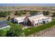 Aerial view of The Aurora Highlands community building featuring solar panels, landscaping, and ample parking at 3341 N Buchanan Way, Aurora, CO 80019