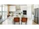 Bright kitchen featuring a spacious island with counter seating and stainless steel appliances at 3341 N Buchanan Way, Aurora, CO 80019