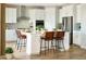 Modern kitchen boasts stainless steel appliances, a large island, and an open concept design at 3341 N Buchanan Way, Aurora, CO 80019