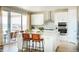 Modern kitchen features a large island with counter seating, pendant lighting, and stainless steel appliances at 3341 N Buchanan Way, Aurora, CO 80019