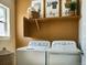 Functional laundry room with modern appliances, shelving, and ample storage at 3341 N Buchanan Way, Aurora, CO 80019