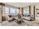 Bright living room featuring hardwood floors, large windows, and stylish furnishings at 3341 N Buchanan Way, Aurora, CO 80019