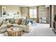 Spacious living room with a large sectional sofa, stylish coffee table, and plenty of natural light at 3341 N Buchanan Way, Aurora, CO 80019
