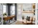 Serene home office features a wood desk and a comfortable sitting area with natural light at 3341 N Buchanan Way, Aurora, CO 80019
