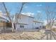 Large backyard featuring mature trees, a wooden fence, and the exterior of the home at 19003 E Oxford Dr, Aurora, CO 80013