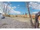 A backyard with a rock ground cover and wooden fence is situated in the rear of the property at 19003 E Oxford Dr, Aurora, CO 80013
