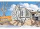 A backyard patio with a fence and mature trees offers a private outdoor space at 19003 E Oxford Dr, Aurora, CO 80013