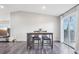 Bright dining area features modern table with seating, hardwood floors and access to outdoor living space at 19003 E Oxford Dr, Aurora, CO 80013