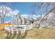 A two-story home exterior features a white wood fence, large windows, and mature trees at 19003 E Oxford Dr, Aurora, CO 80013