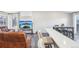 An open living room featuring a television, breakfast bar, and dining area with modern finishes at 19003 E Oxford Dr, Aurora, CO 80013