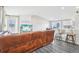 A spacious living room featuring gray hardwood flooring, an entertainment center, and a bar seating area at 19003 E Oxford Dr, Aurora, CO 80013
