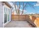 A backyard patio with a wooden fence provides privacy and space for outdoor enjoyment at 19003 E Oxford Dr, Aurora, CO 80013