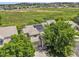 Aerial view of a home with solar panels, surrounded by mature trees in a neighborhood at 19463 E Hollow Creek Dr, Parker, CO 80134