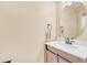 Bathroom featuring a wooden vanity with a modern sink and a round mirror at 19463 E Hollow Creek Dr, Parker, CO 80134
