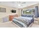 Comfortable bedroom featuring a ceiling fan, window, and dresser with a wall-mounted television at 19463 E Hollow Creek Dr, Parker, CO 80134