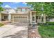 Charming two-story home featuring a two-car garage and a beautifully landscaped front yard at 19463 E Hollow Creek Dr, Parker, CO 80134