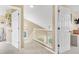 Bright hallway featuring neutral walls, white trim and railing, with an abundance of natural light streaming through the windows at 19463 E Hollow Creek Dr, Parker, CO 80134