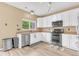 Bright kitchen featuring white cabinets, stainless steel appliances, and a functional layout at 19463 E Hollow Creek Dr, Parker, CO 80134