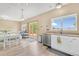 Open kitchen with a sliding door to a deck, open floor plan, and light wood floors at 19463 E Hollow Creek Dr, Parker, CO 80134