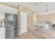 Open kitchen featuring stainless steel appliances, white cabinets, and light wood floors at 19463 E Hollow Creek Dr, Parker, CO 80134
