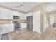 Open kitchen featuring stainless steel appliances, white cabinets, and light wood floors at 19463 E Hollow Creek Dr, Parker, CO 80134
