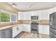 Well-equipped kitchen with white cabinets, stainless steel appliances, and a functional layout at 19463 E Hollow Creek Dr, Parker, CO 80134