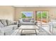 Bright living area with comfortable couches, stylish rug, and access to outdoor deck at 19463 E Hollow Creek Dr, Parker, CO 80134