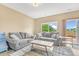 Cozy living room with comfortable couches, a stylish rug, and a view of the deck at 19463 E Hollow Creek Dr, Parker, CO 80134