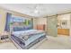 Cozy main bedroom with a comfortable bed, a large window, and a barn door to the bathroom at 19463 E Hollow Creek Dr, Parker, CO 80134
