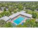 Aerial view of a large community pool surrounded by lounge chairs and lush greenery at 19463 E Hollow Creek Dr, Parker, CO 80134