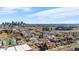 Aerial view of neighborhood homes with the city skyline in the background on a clear day at 2146 Federal Blvd, Denver, CO 80211