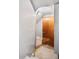 A staircase leading to a basement door, lit by a single light bulb at 2146 Federal Blvd, Denver, CO 80211