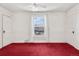 This is a bedroom featuring red carpeting, white walls and a large window at 2146 Federal Blvd, Denver, CO 80211