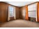 Cozy room featuring wood paneled walls and carpeting at 2146 Federal Blvd, Denver, CO 80211