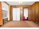 Cozy room featuring wood paneled walls and carpeting at 2146 Federal Blvd, Denver, CO 80211